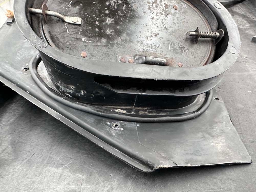 A black metal object is sitting on top of a black surface.