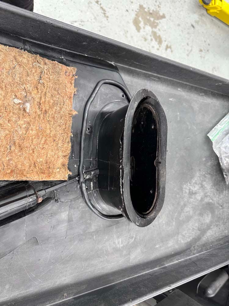 A black pipe is sitting on top of a black tray.