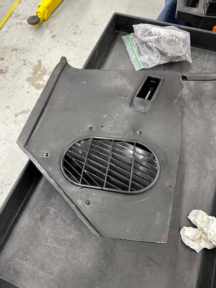 A piece of metal is sitting on top of a plastic tray.