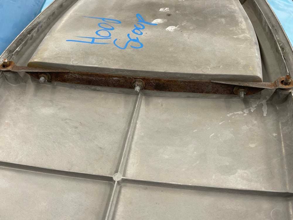 A piece of metal with the words hood seal written on it