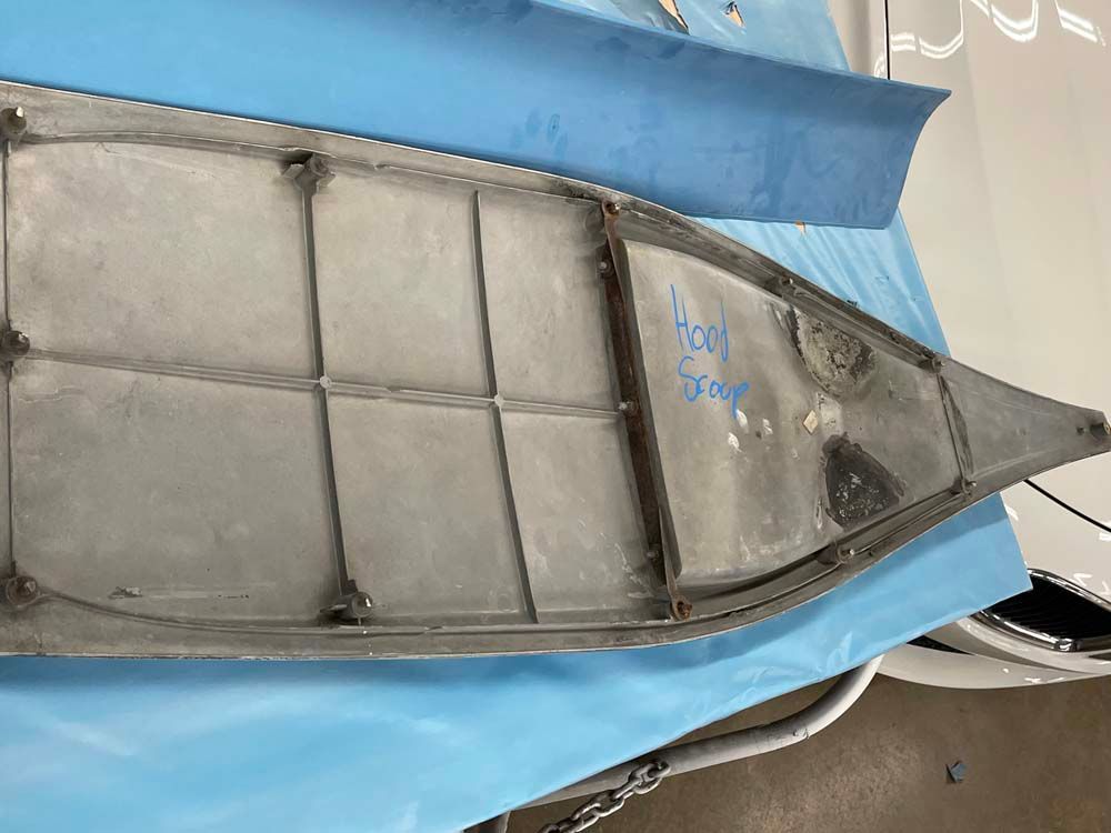 A canoe is sitting on top of a blue cloth