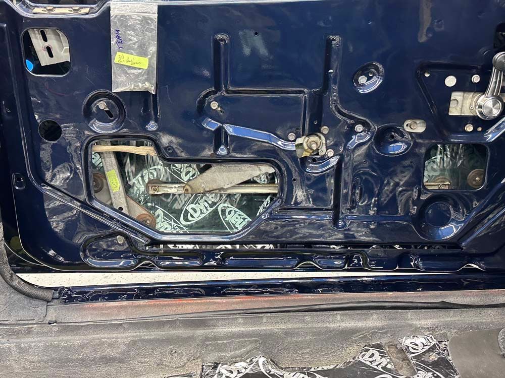 A close up of the back of a car with a broken door.
