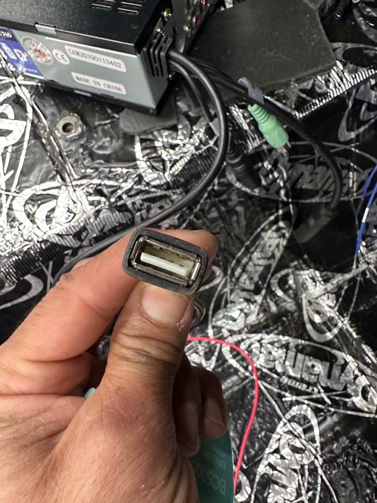 A person is holding a usb cable in their hand.