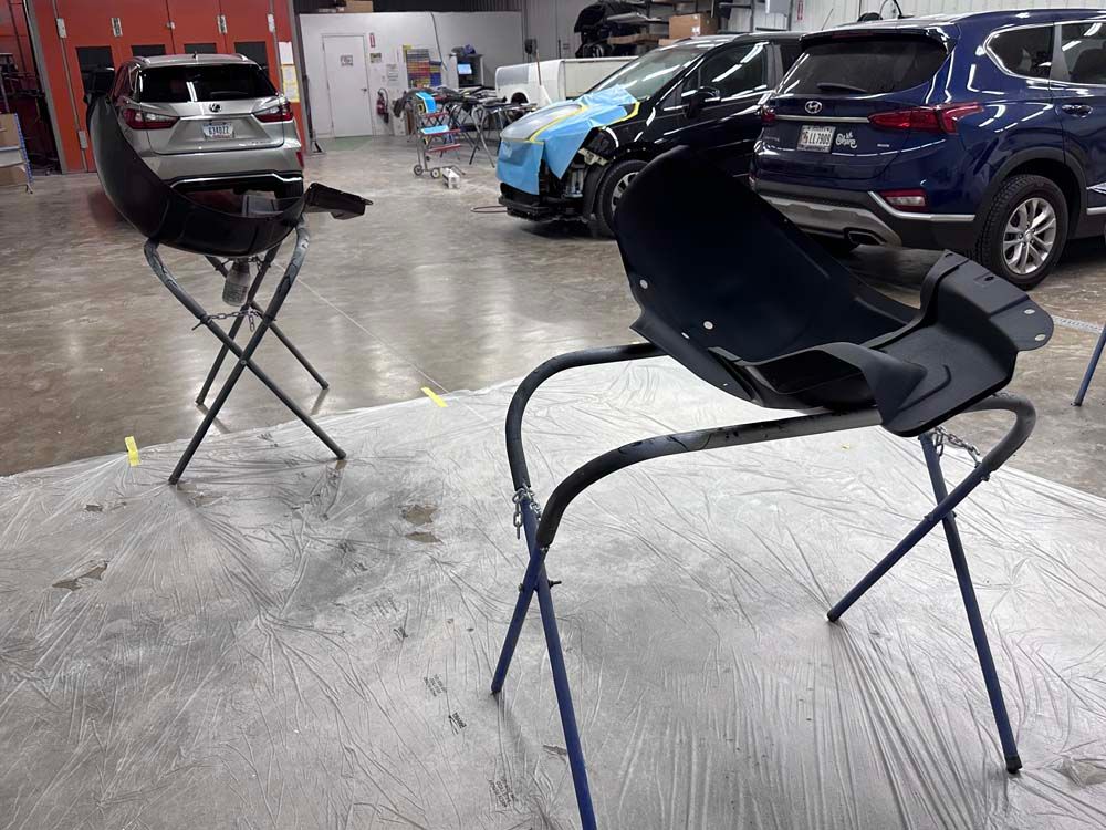 A couple of chairs sitting on top of a table in a garage.