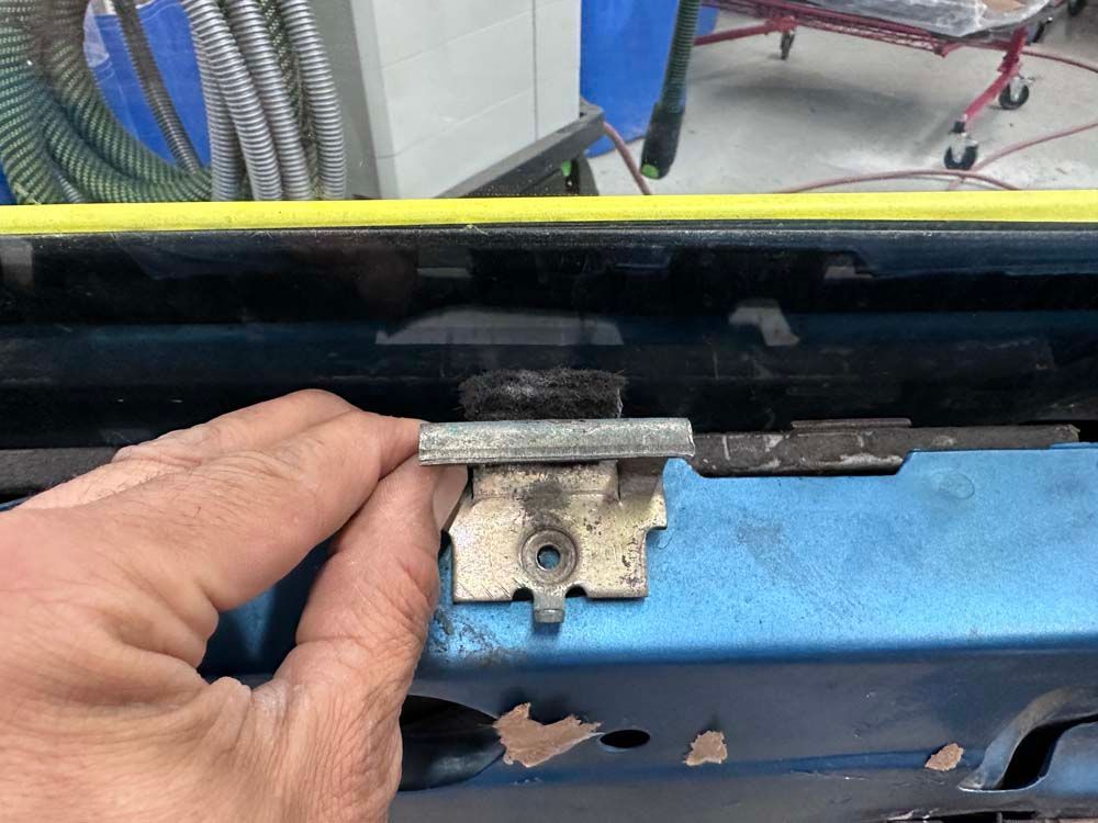 A person is holding a piece of metal in their hand.