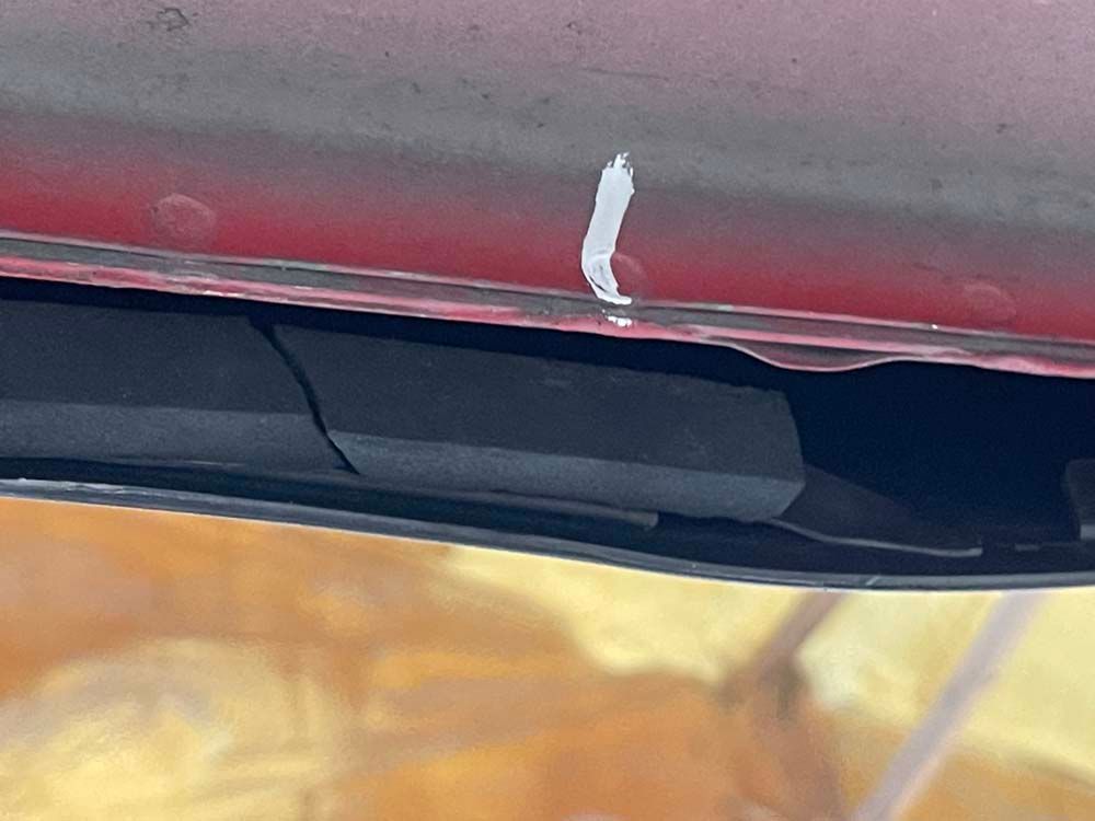 A close up of the underside of a red car