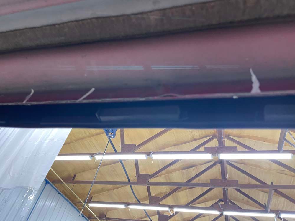 The ceiling of a building with a lot of lights hanging from it.