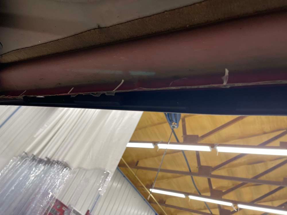 A white curtain is hanging from the ceiling of a building