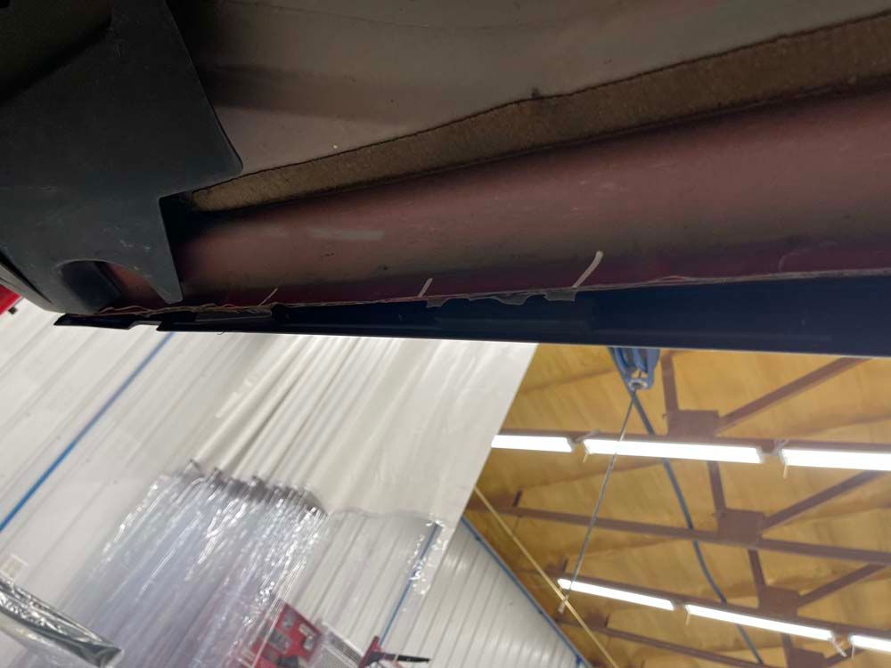 A ceiling of a building with a clear curtain hanging from it