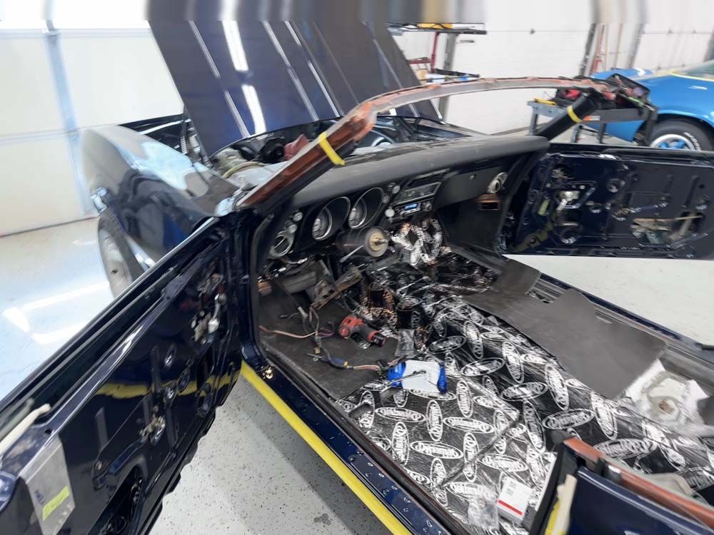 The inside of a black car with the hood open