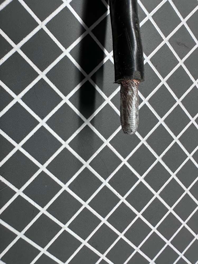 A close up of a pen on a black and white checkered surface.