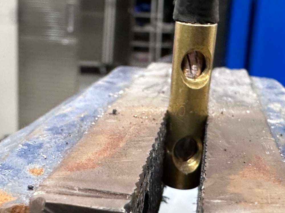 A piece of metal is sitting on top of a vise.