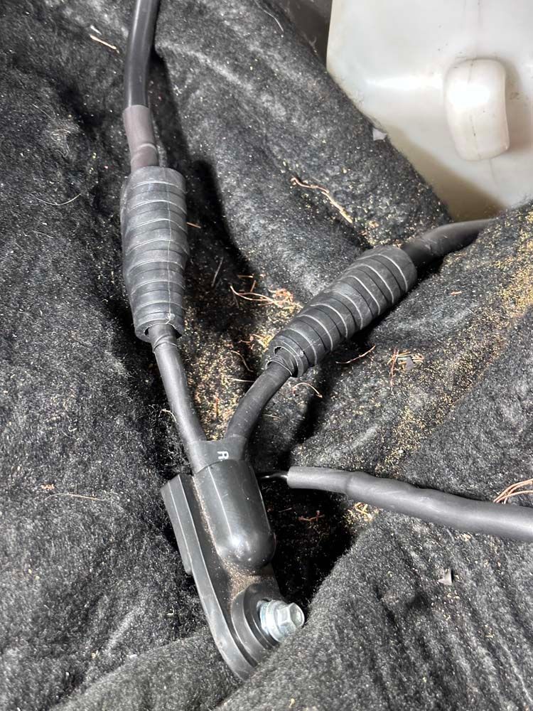 A close up of a pair of wires connected to a hose.