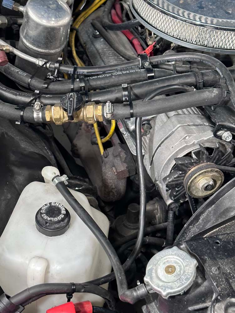 A close up of a car engine with a radiator cap