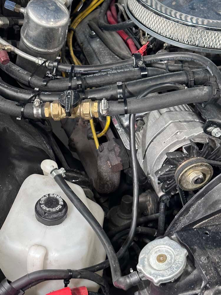 A close up of a car engine with a radiator cap