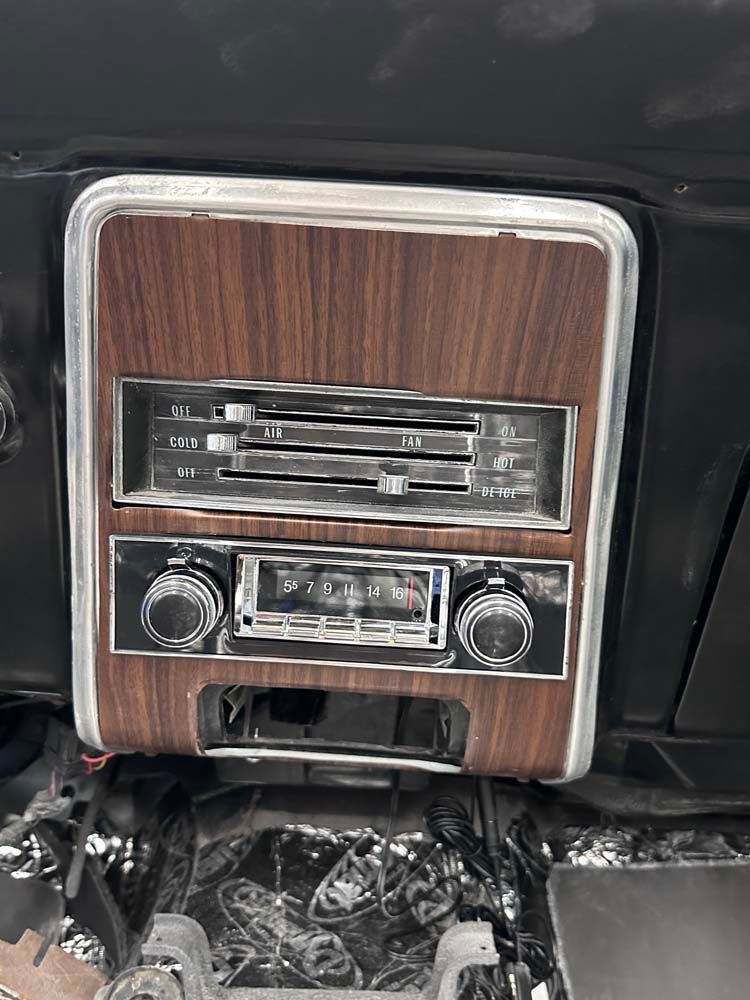 A close up of a wooden dashboard in a car.