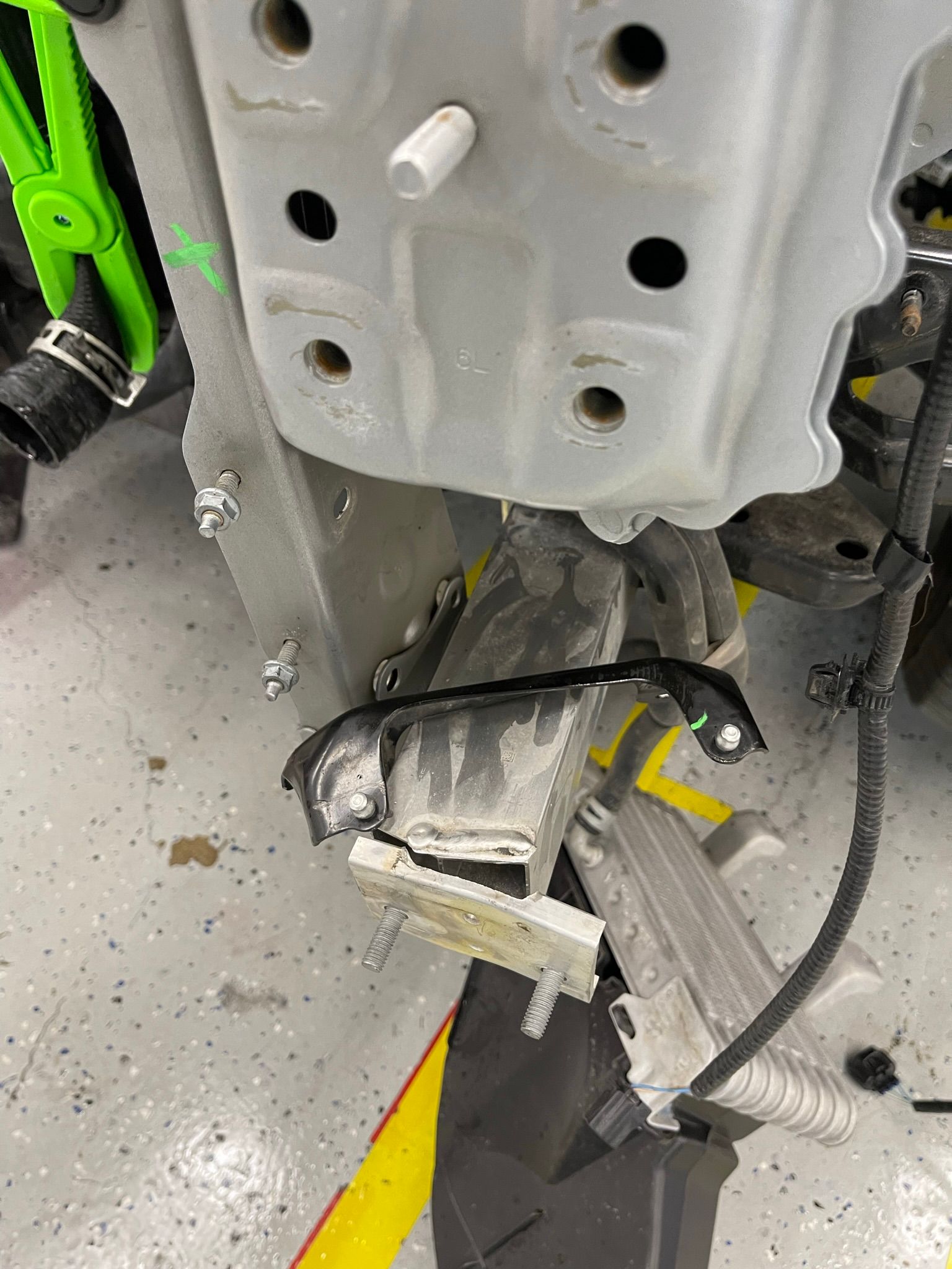 A close up of a piece of metal that is being removed from a car.