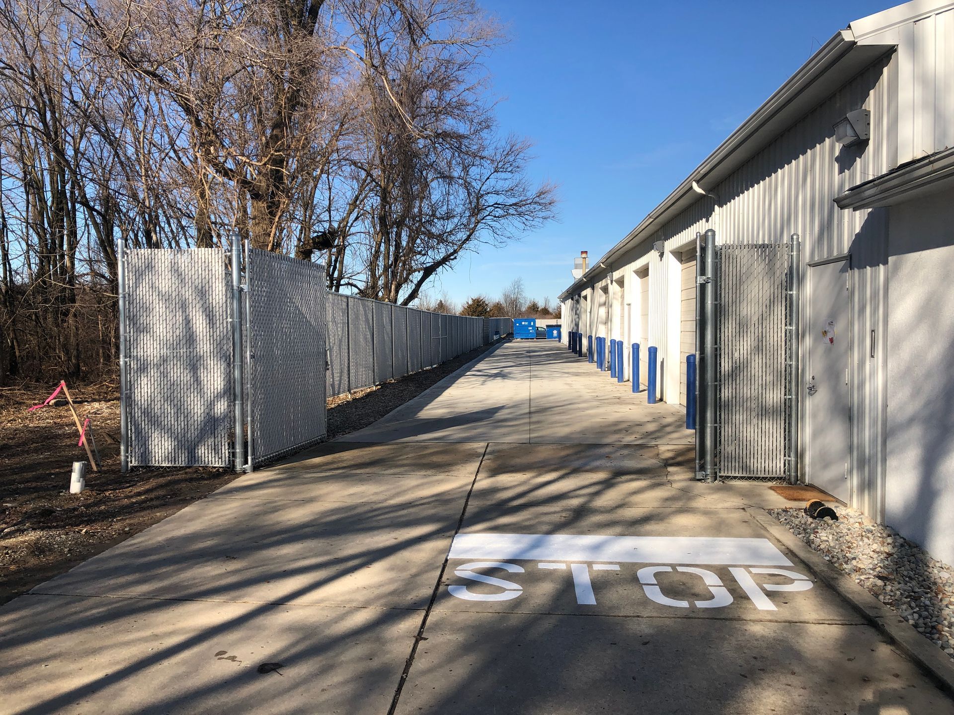 A stop sign is painted on the sidewalk in front of a building.