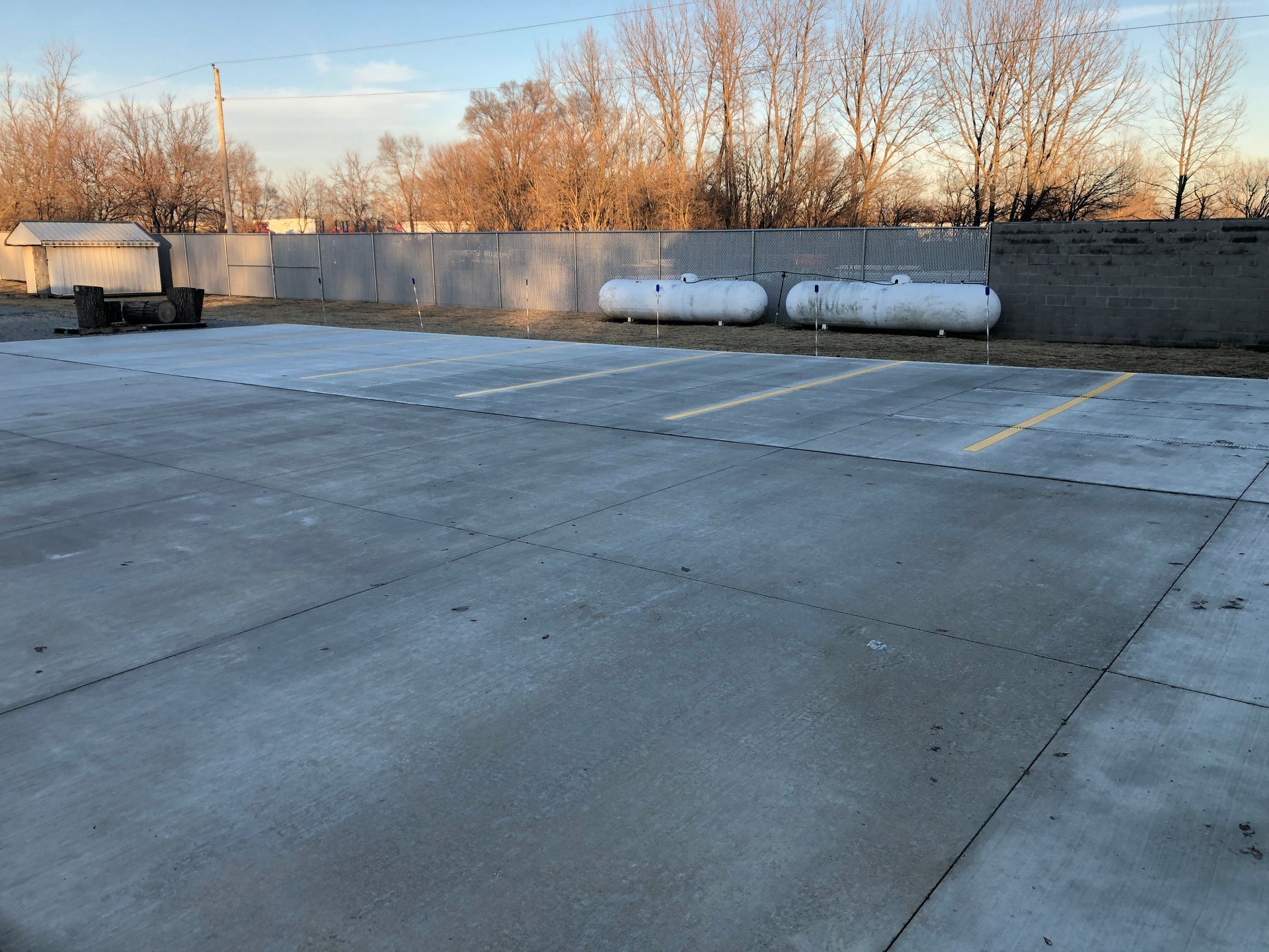 A parking lot with two propane tanks in it