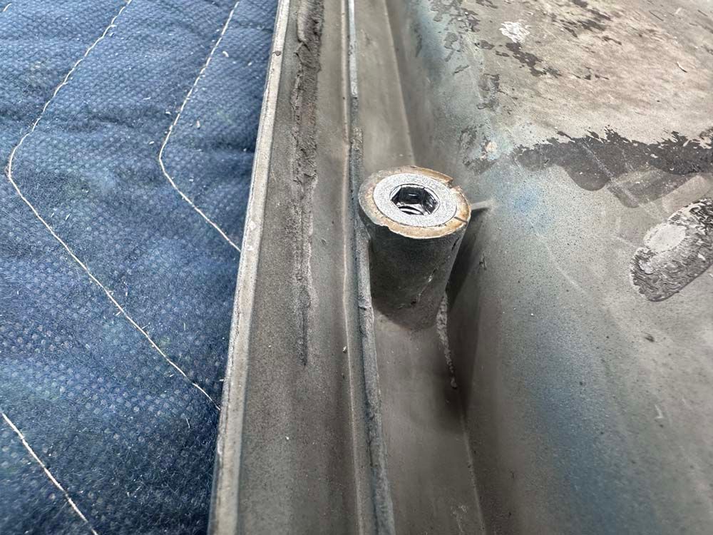 A close up of a piece of metal with a hole in it.