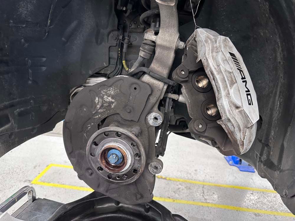 A close up of a brake caliper on a car.