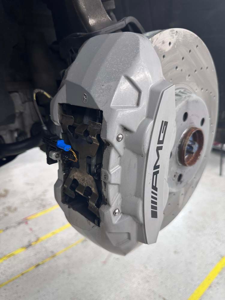 A close up of a brake caliper on a car.