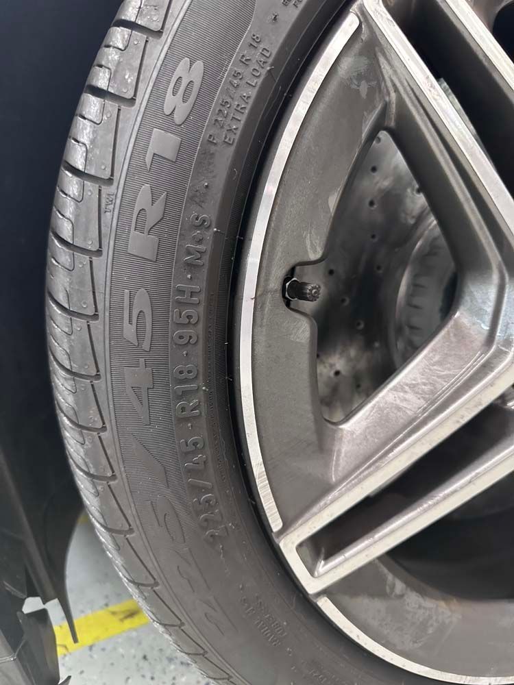 A close up of a tire on a car wheel.
