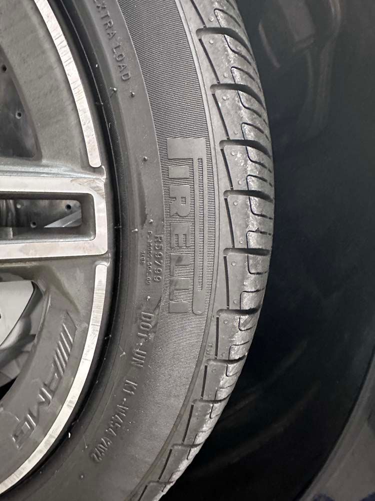 A close up of a tire on a car wheel.