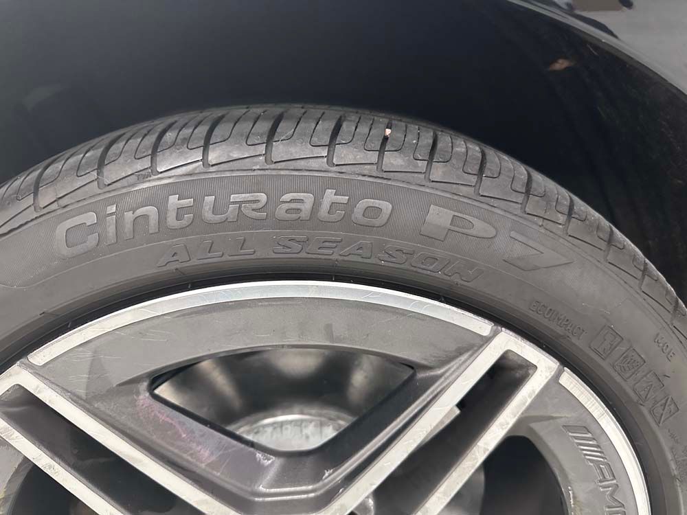 A close up of a cinturato all season tire on a car