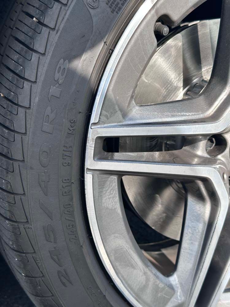 A close up of a tire on a car wheel.