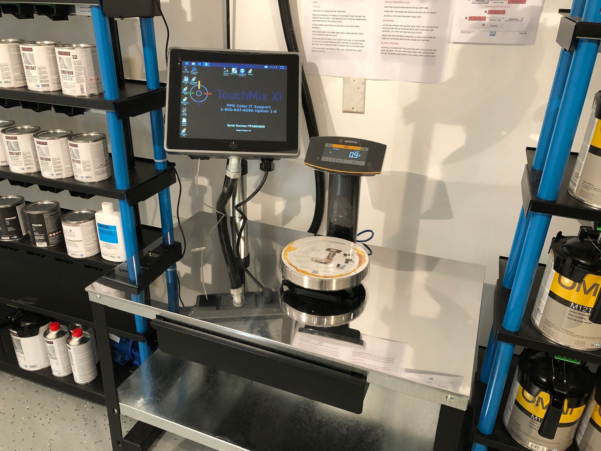 A computer monitor is sitting on top of a metal table.