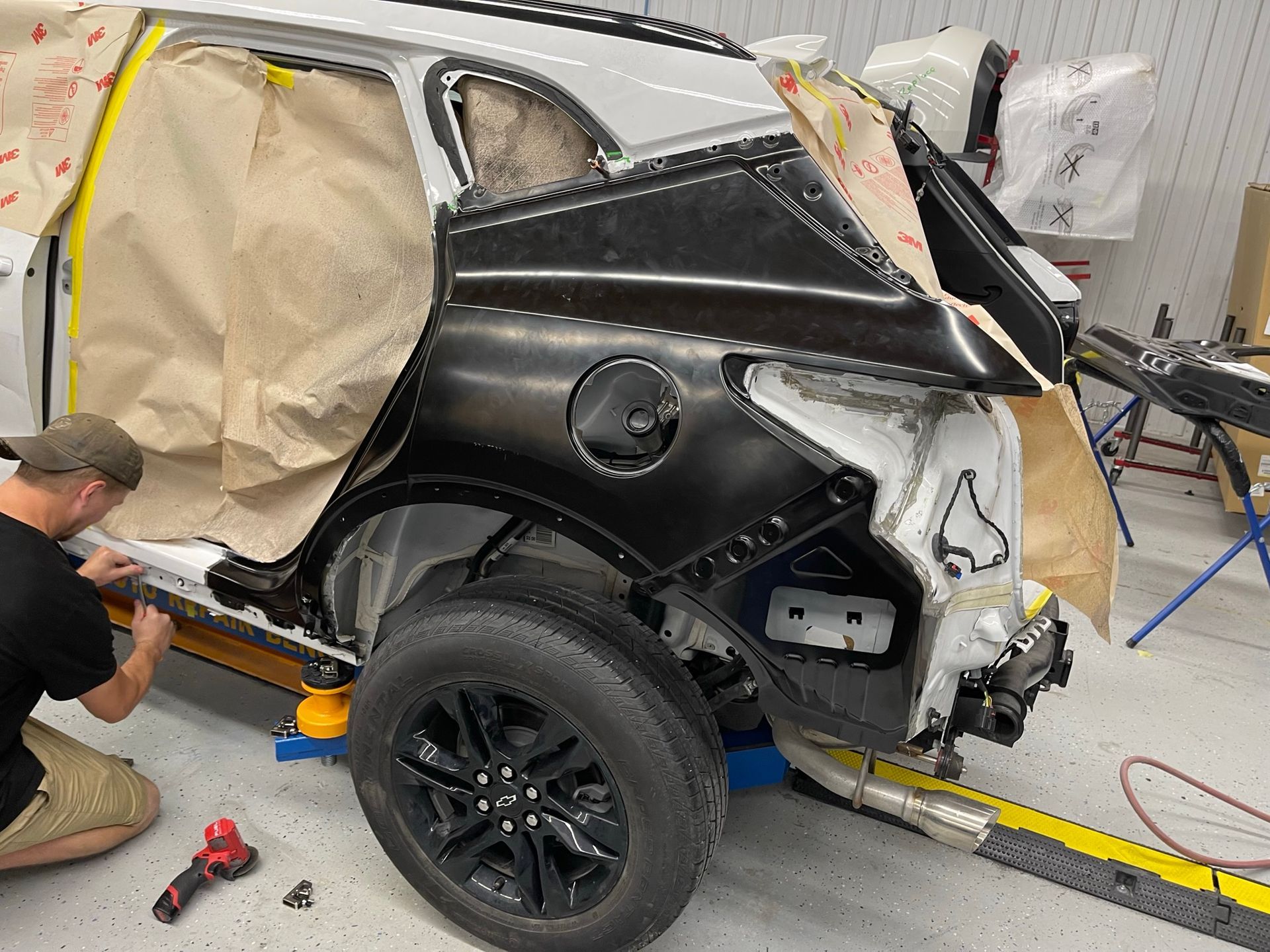 A man is working on a car in a garage.