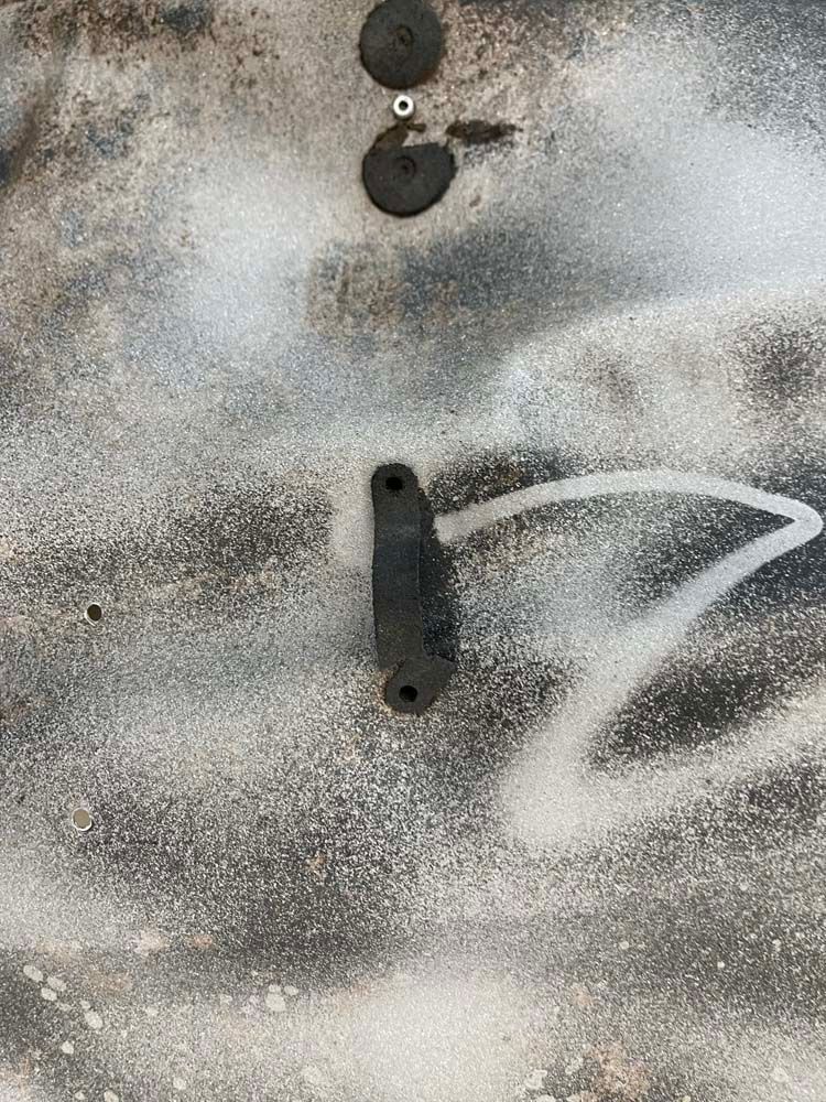 A close up of a piece of metal on a concrete surface.