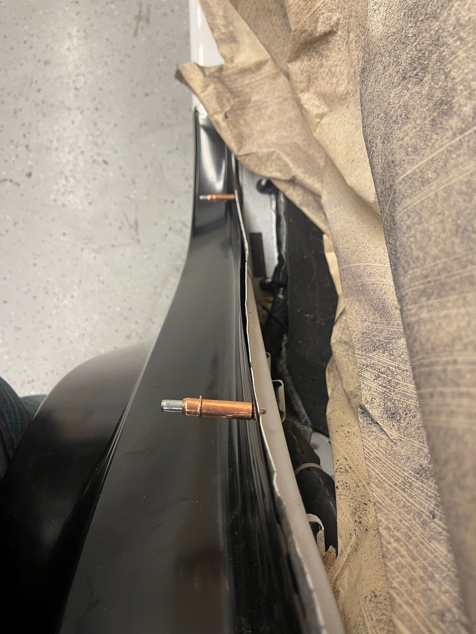 A close up of a piece of metal with screws on it.