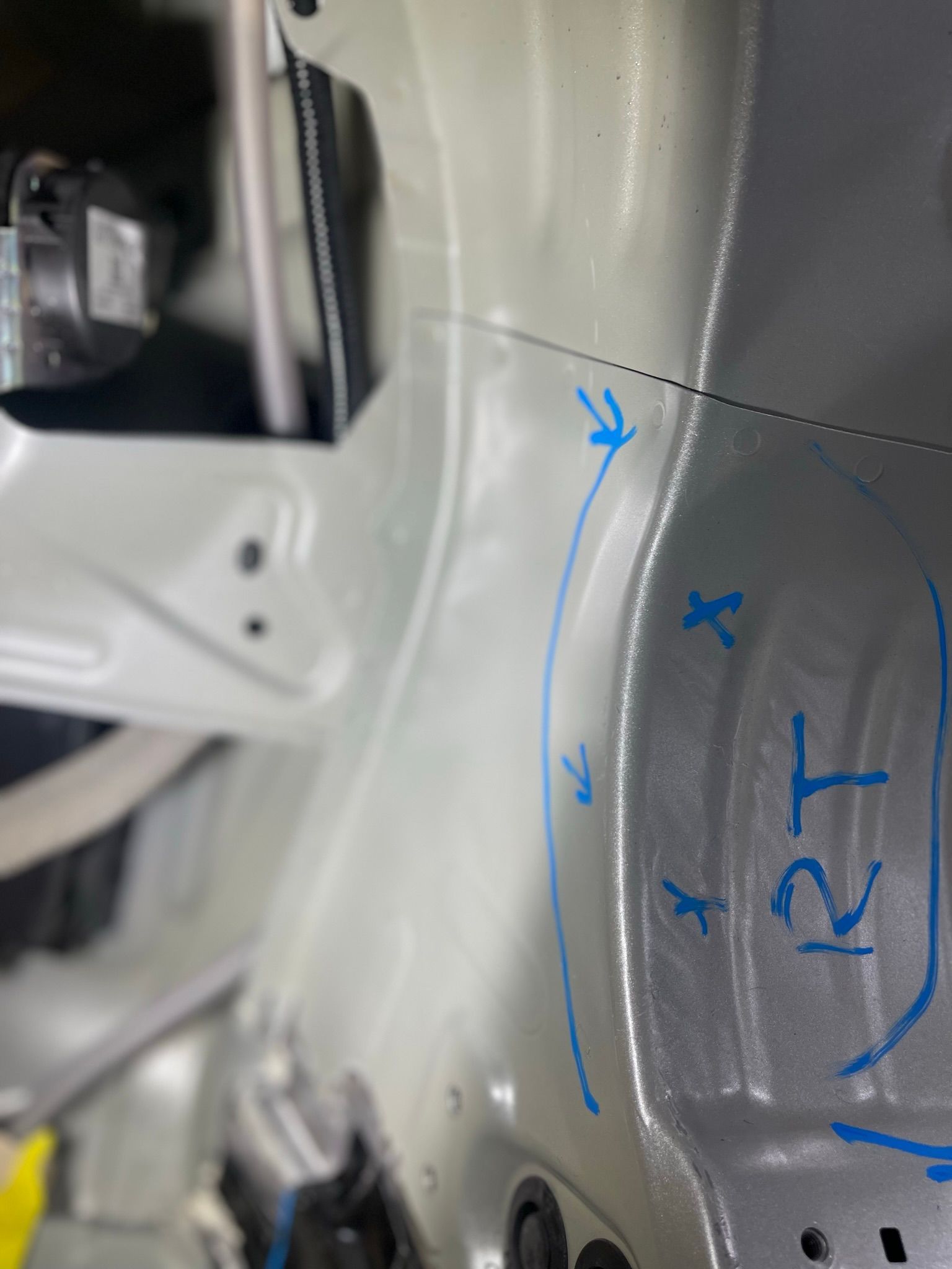 A close up of a car with blue markings on it.