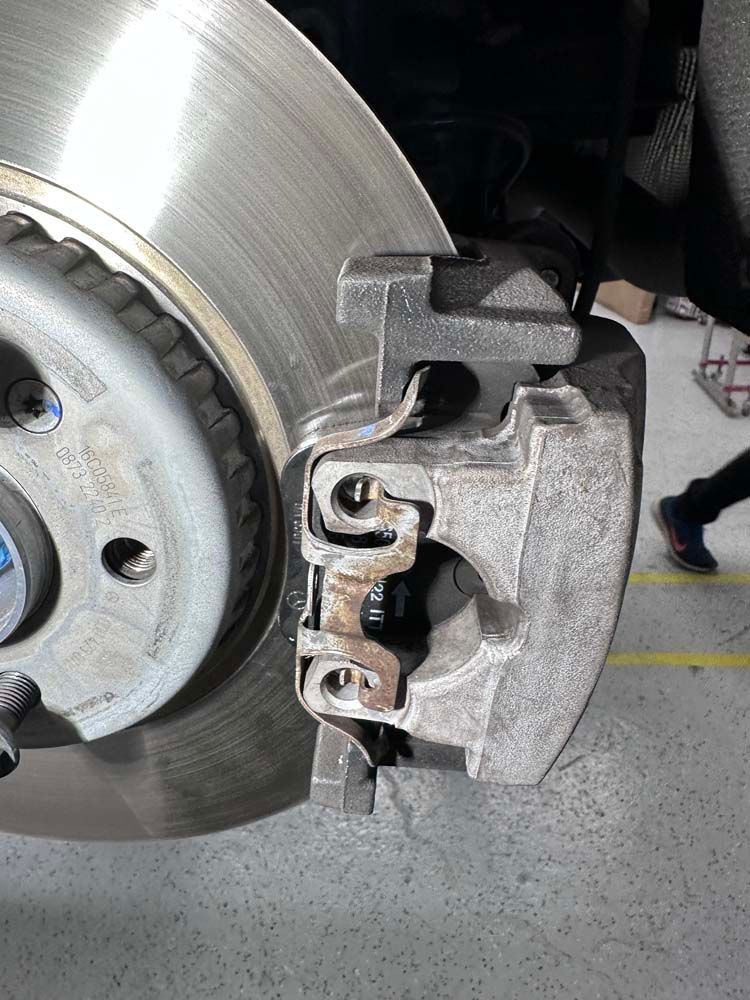 A close up of a brake caliper on a car.