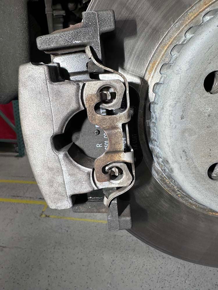 A close up of a brake caliper on a car.