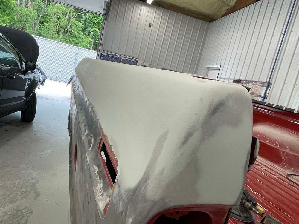 A car is being worked on in a garage.