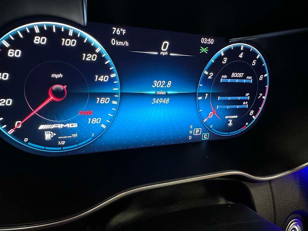 A close up of a car 's dashboard shows that the temperature is 76 degrees