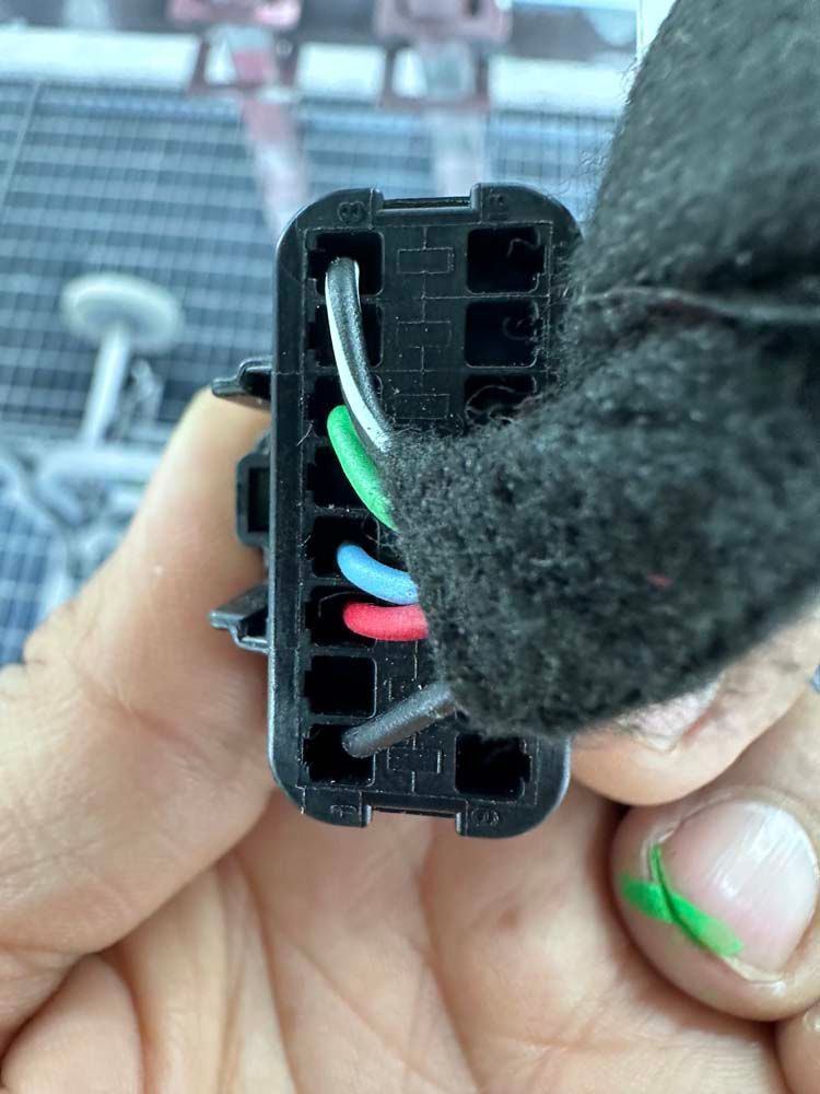 A close up of a person holding a connector in their hand.