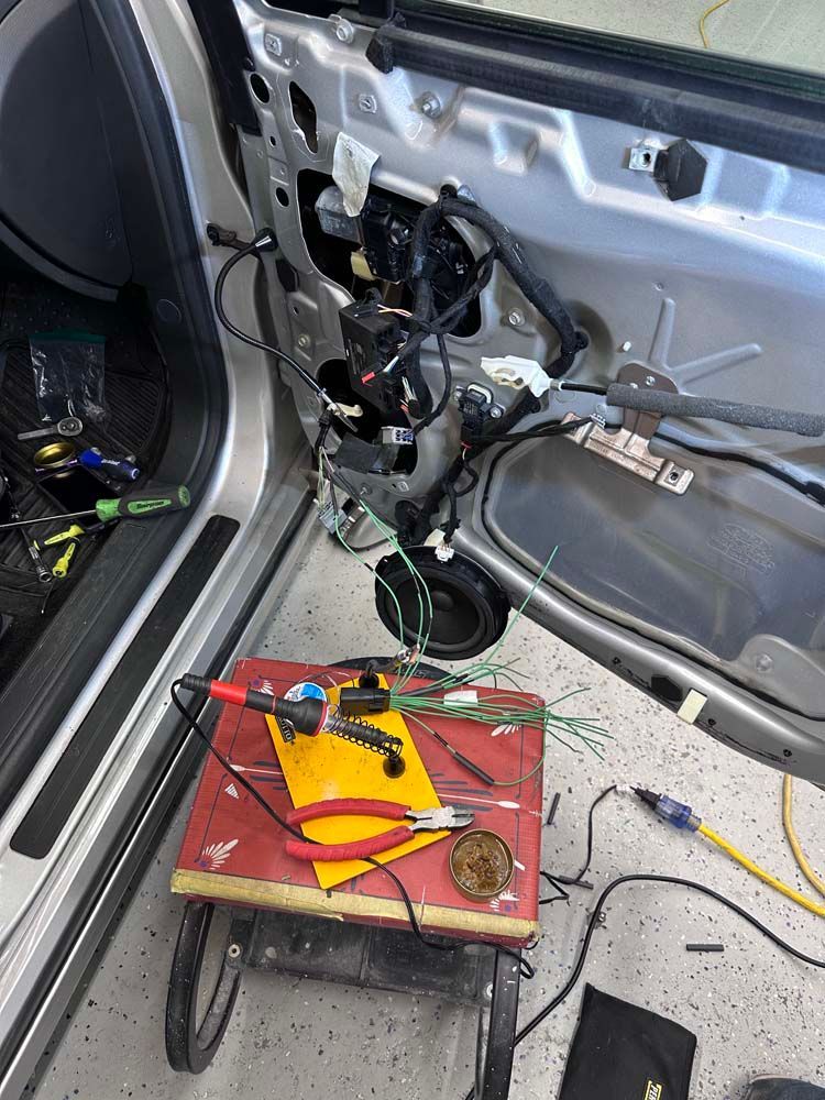 A car is being worked on in a garage.