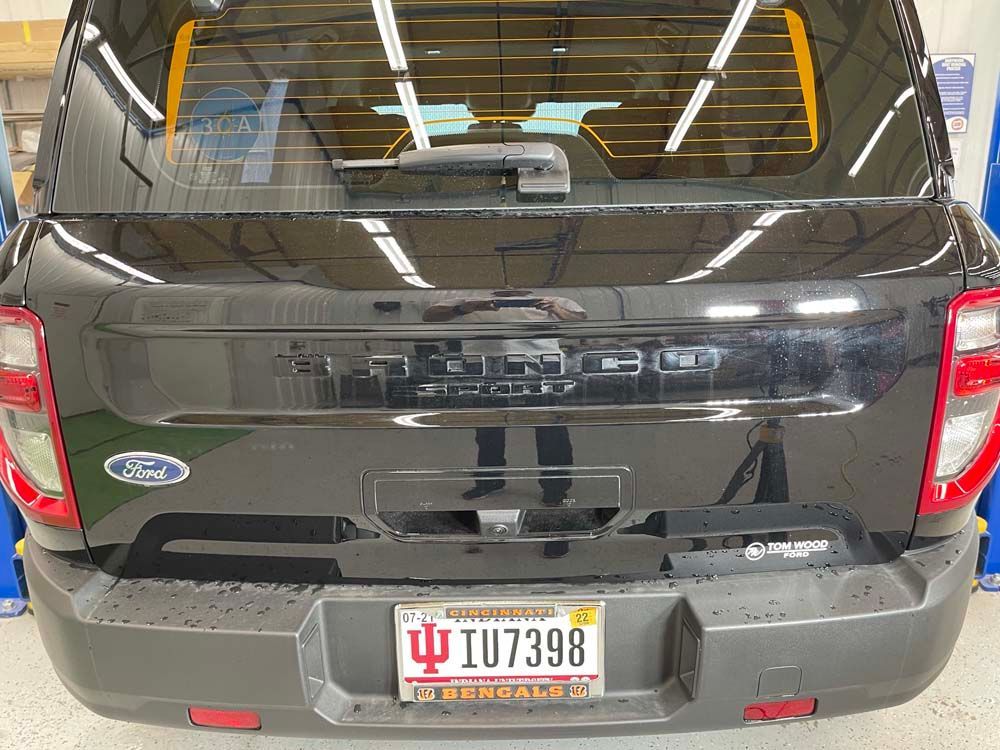 A black ford truck with a license plate that says i07398