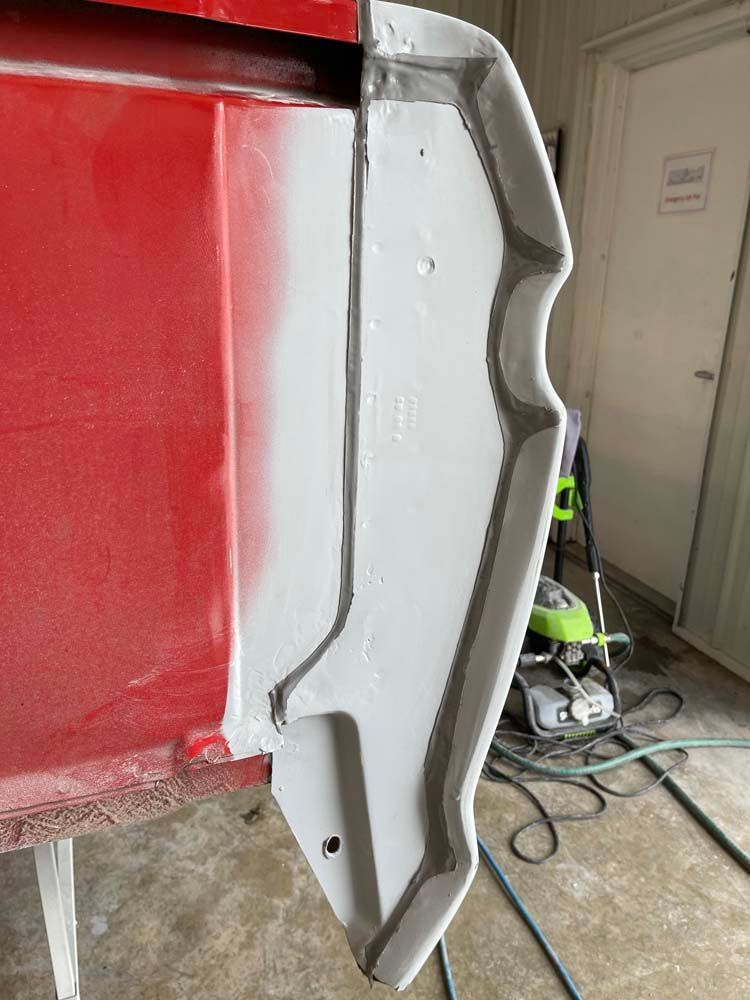 A close up of a red and white object in a garage.