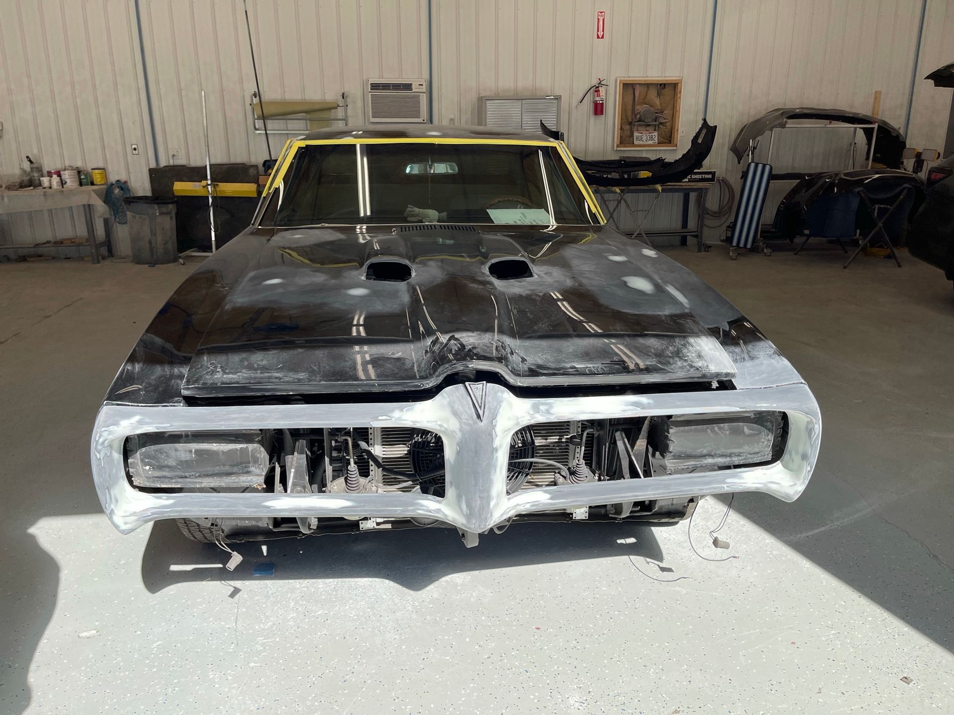 A black and yellow car is parked in a garage