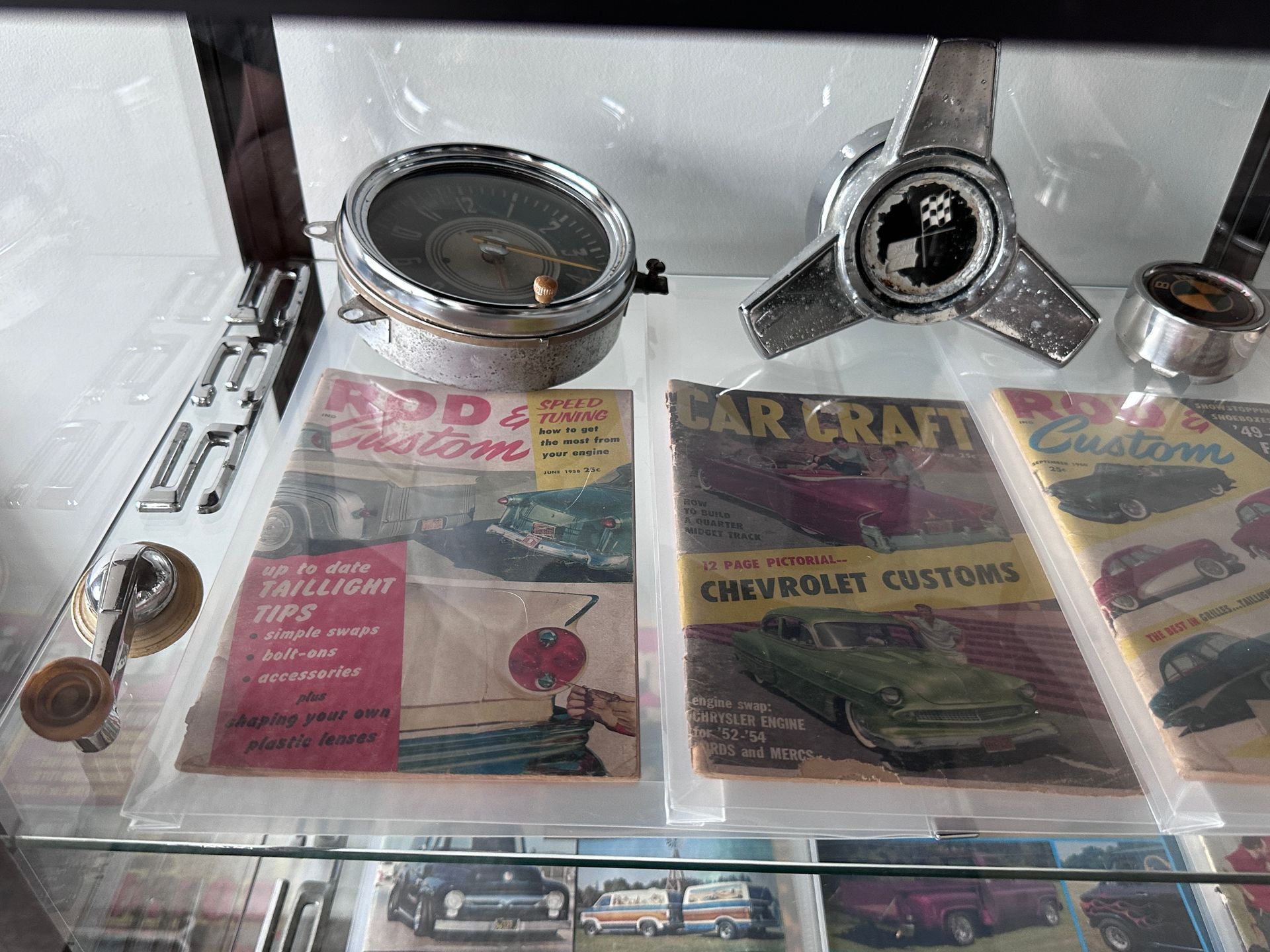 A display case filled with a variety of old cars and magazines.