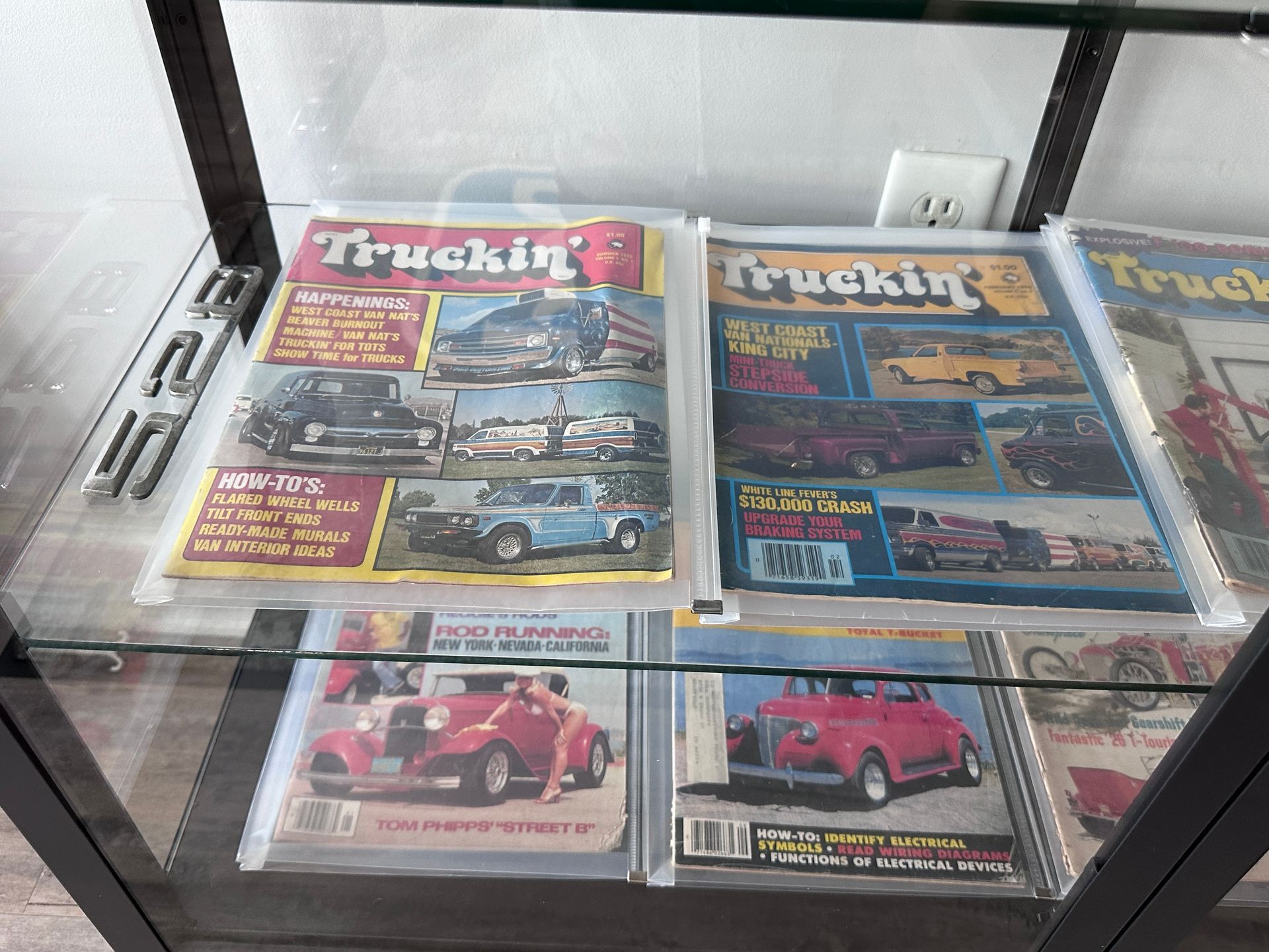 A display case filled with magazines including truckin '