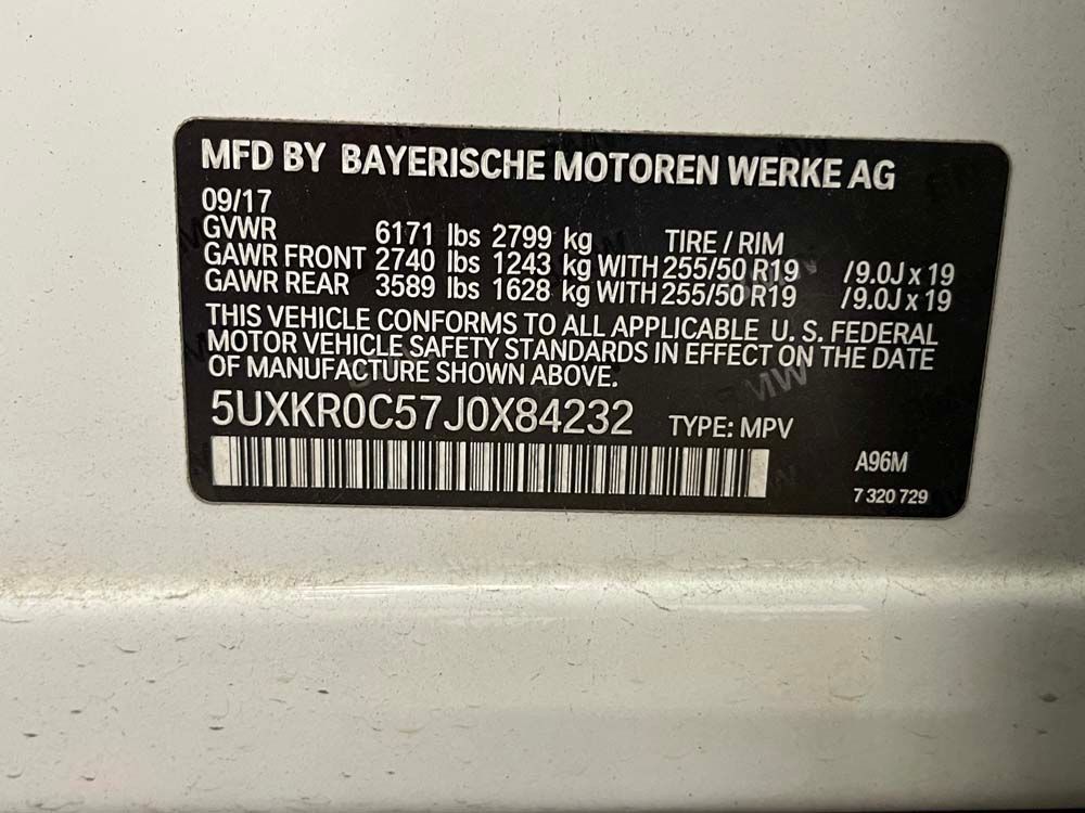 A sticker on a car that says mfd by bayerische motoren werke ag