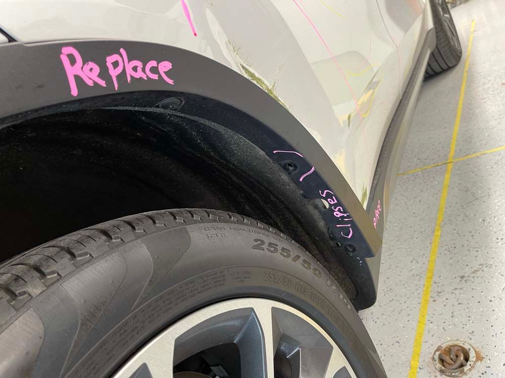 A car with the word replace written on the fender