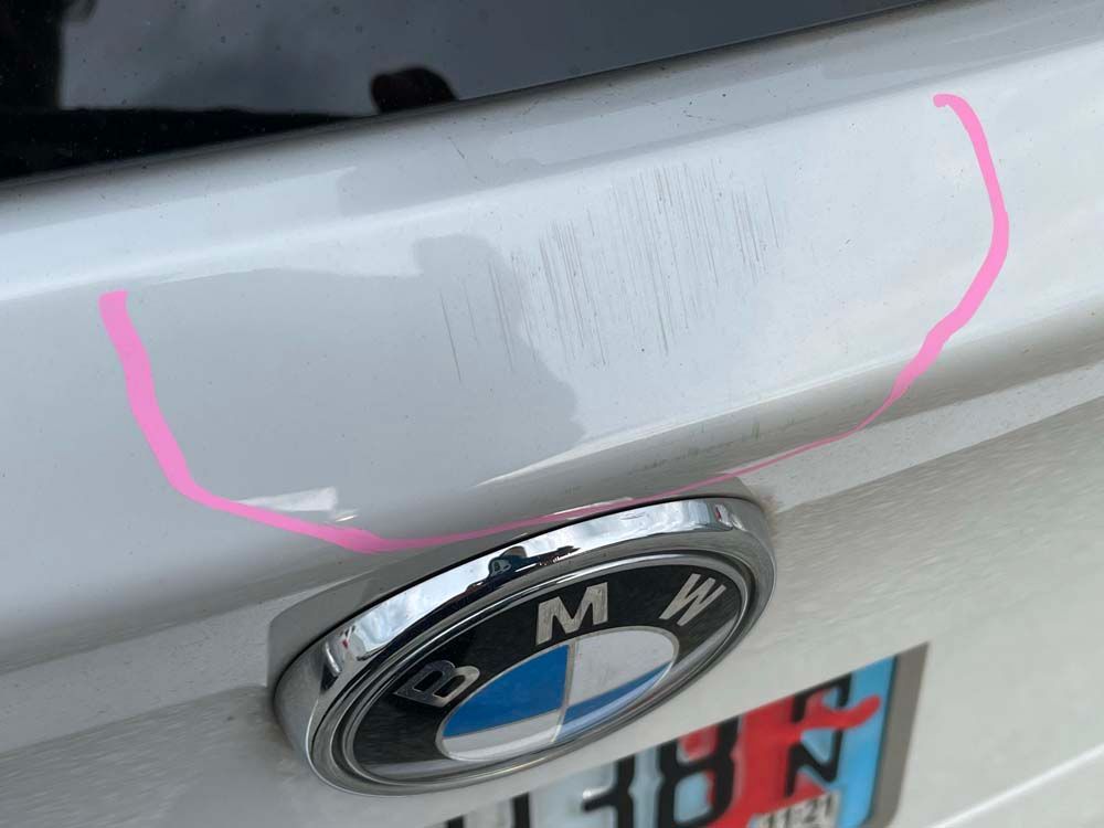 A close up of a bmw emblem on a white car