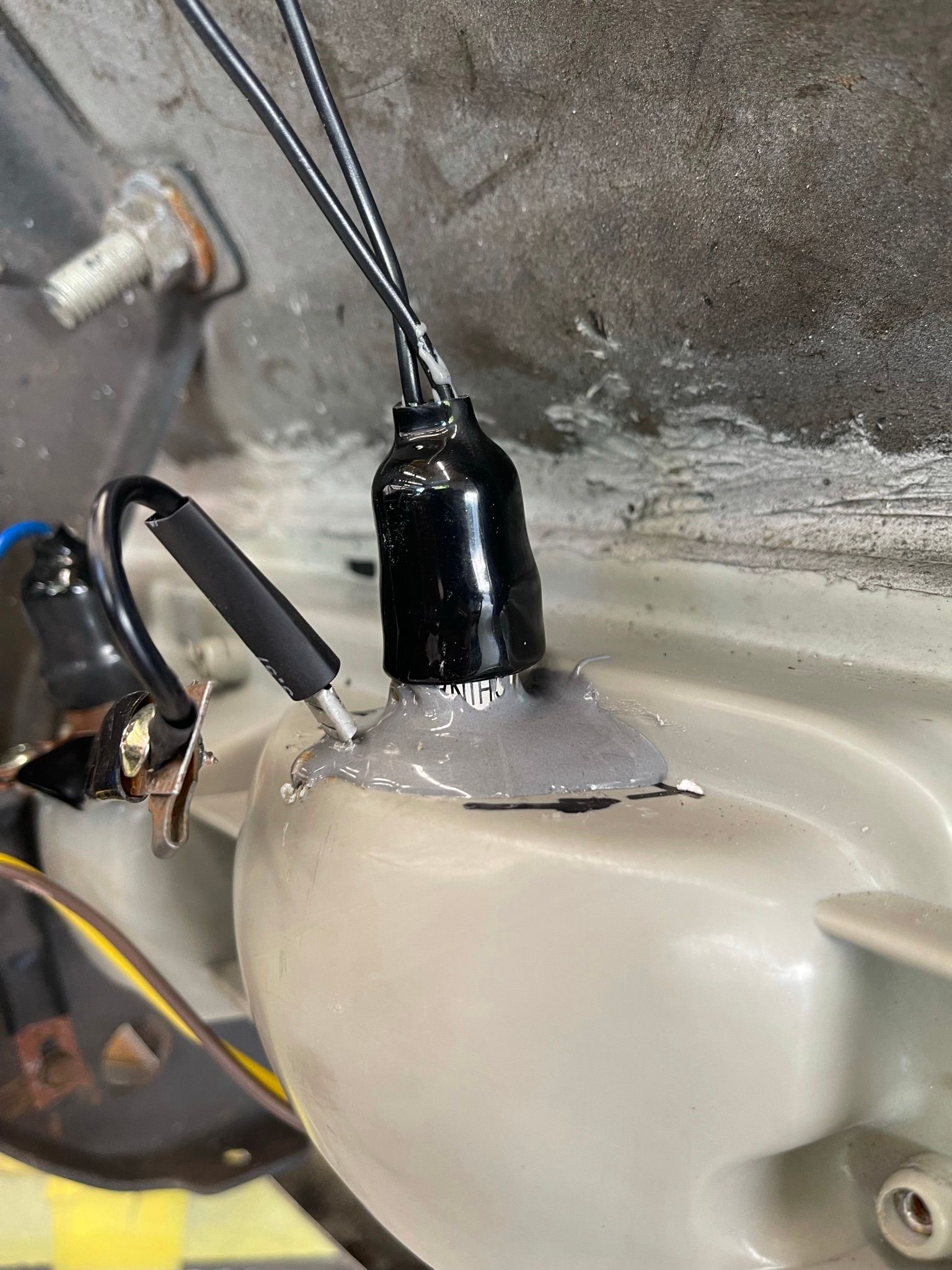 A close up of a light bulb with wires attached to it.